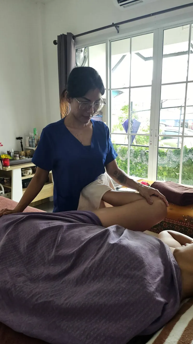 Therapist massaging a client's legs